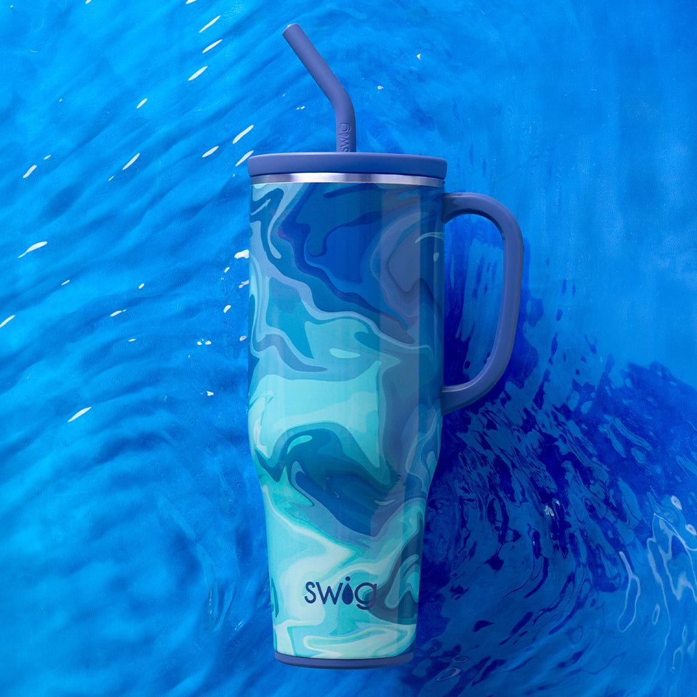 Swig Life Blue Lagoon 40oz Mega Mug shot against a deep blue water background