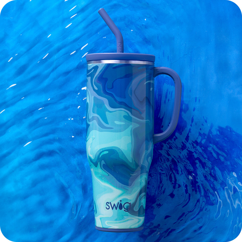 Swig Life Blue Lagoon 40oz Mega Mug shot against a deep blue water background