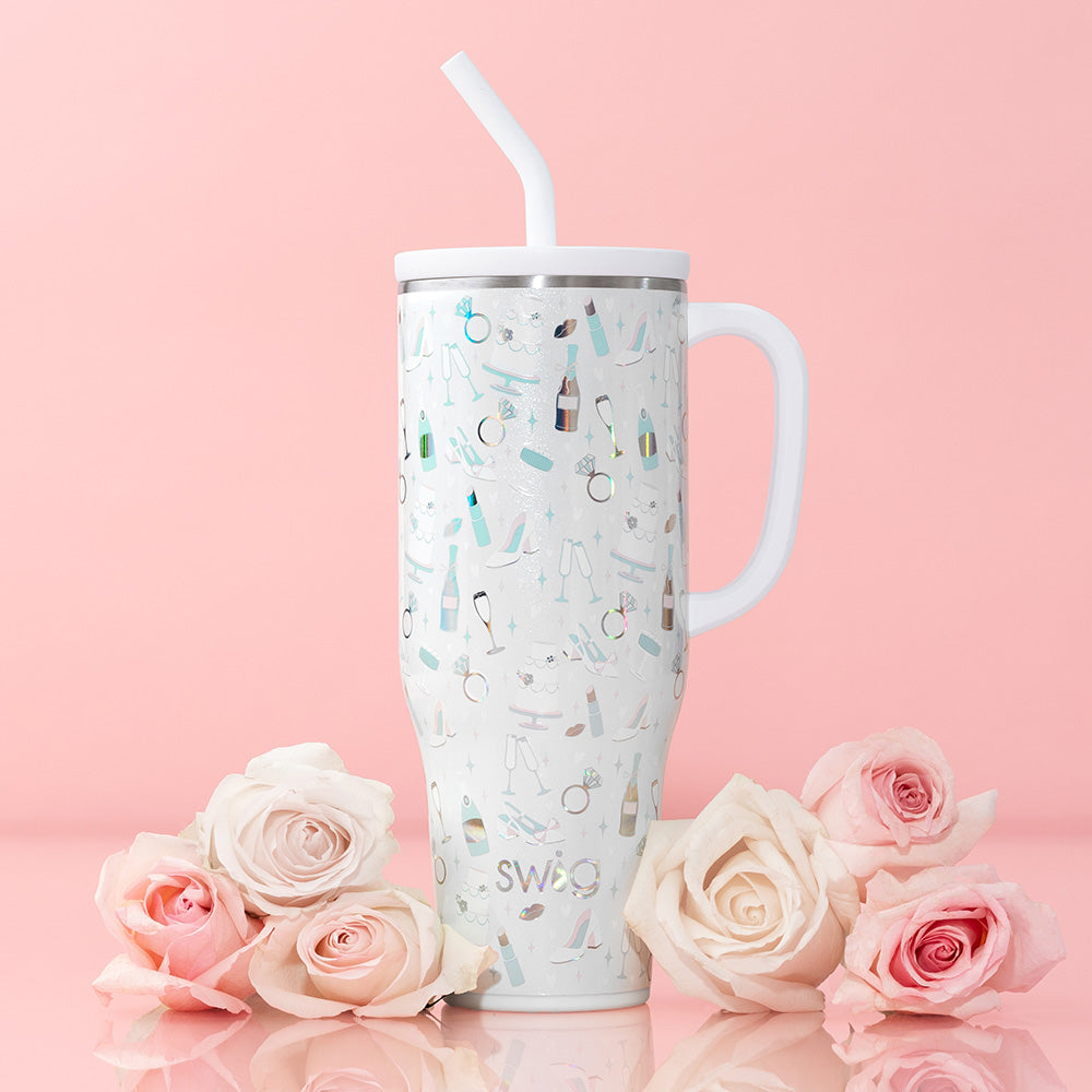 Swig Life 40oz Mega Mug Insulated Tumbler in Bride to Be shot on a light pink background with roses