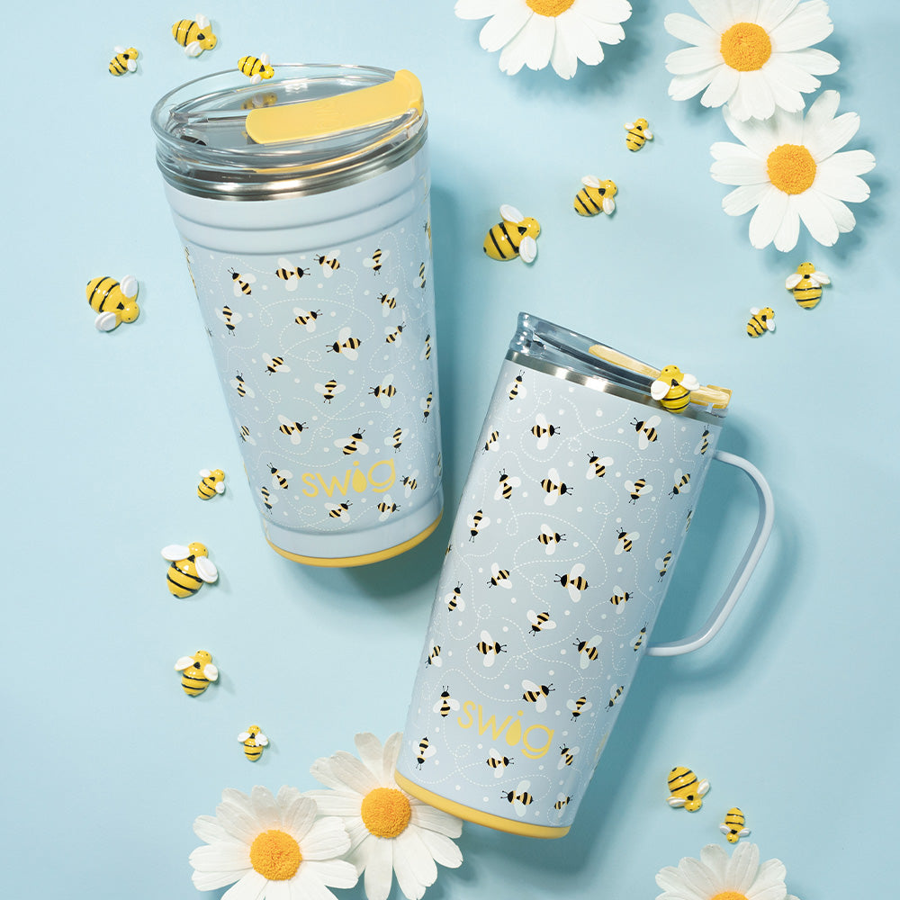 Swig Life Busy Bee 24oz Party Cup and 22oz Travel Mug shot on a light blue background with yellow bees and white daisies