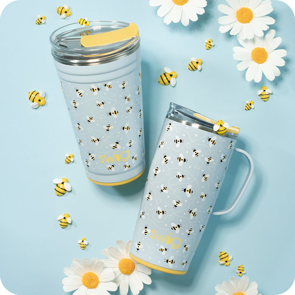 Swig Life Busy Bee 24oz Party Cup and 22oz Travel Mug shot on a light blue background with yellow bees and white daisies