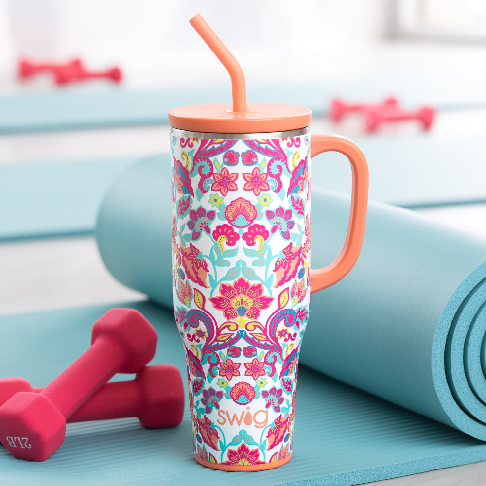 Swig Life Flourish 40oz Mega Mug shot with 2lb weights and a blue yoga mat
