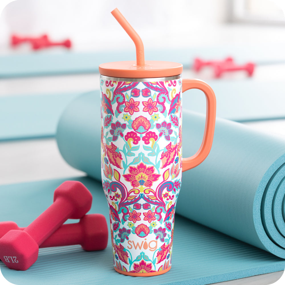 Swig Life Flourish 40oz Mega Mug shot with 2lb weights and a blue yoga mat