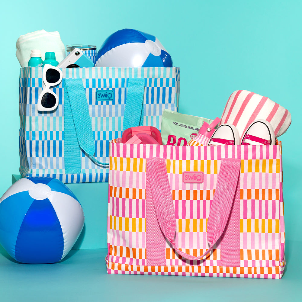 Swig Life Glacier Stripe and Sherbet Stripe Jumbo Tote Bags shot together with beach balls and pool essentials