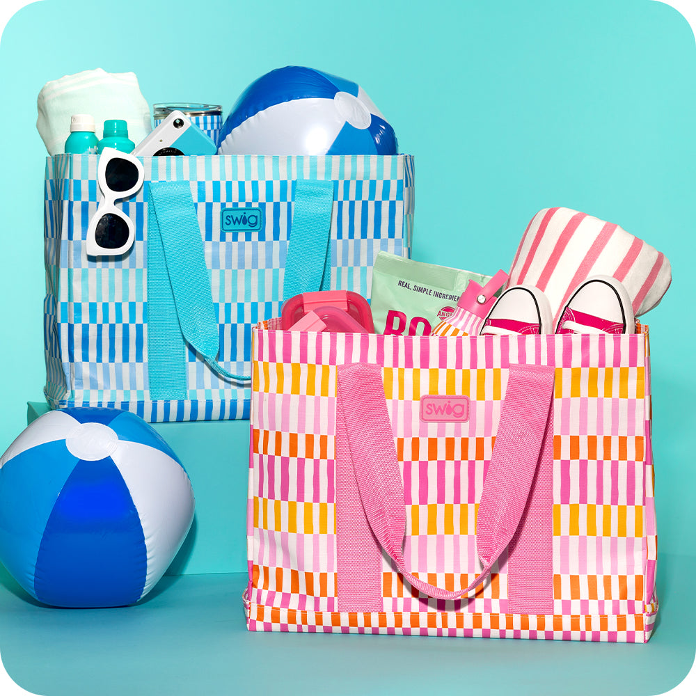 Swig Life Glacier Stripe and Sherbet Stripe Jumbo Tote Bags shot together with beach balls and pool essentials