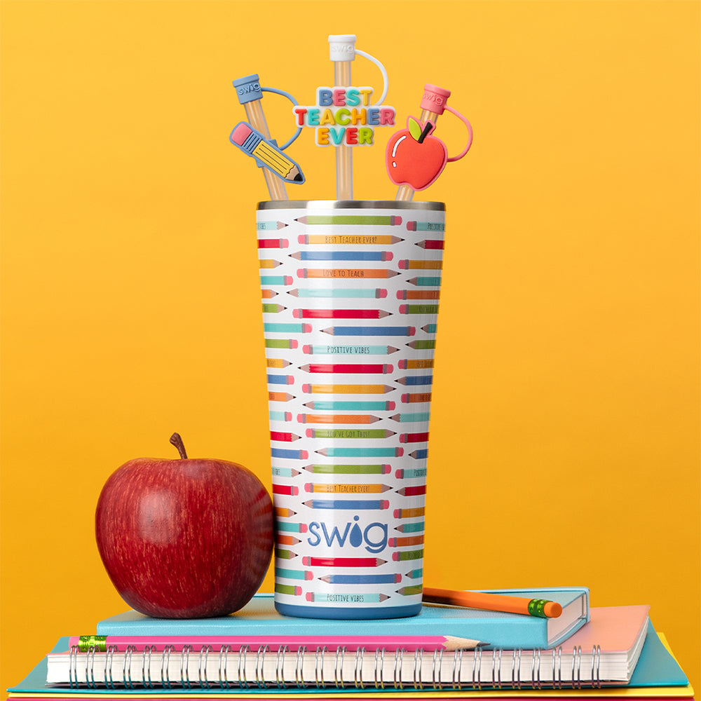 Swig Life Teacher Life 32oz Tumbler with Teacher Life Straw Topper Set shot on a yellow background with a red apple and a stack of notebooks and pencils