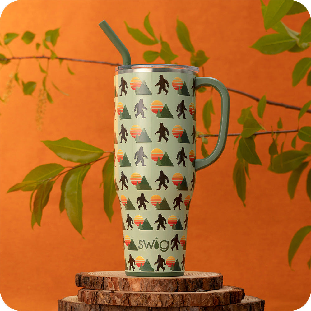 Swig Life 40oz Wild Thing Insulated Mega Mug on an orange background with plants