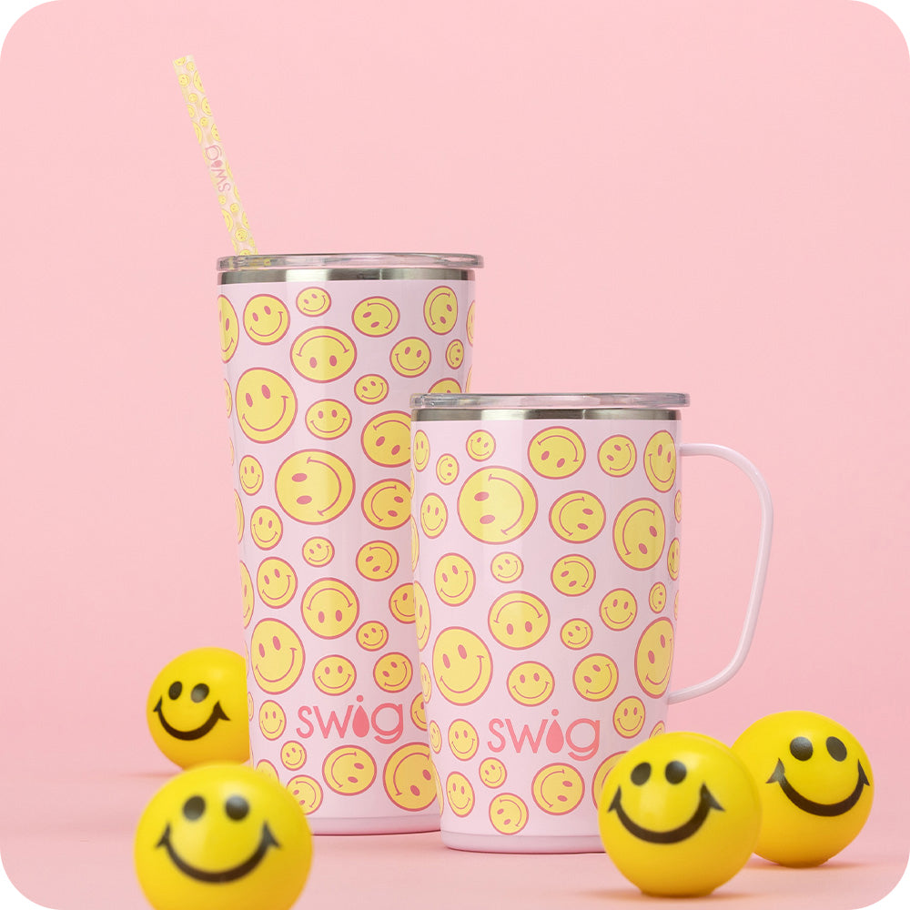 Swig Life Insulated Oh Happy Day 18oz Travel Mug and 22oz Tumbler on a pink background