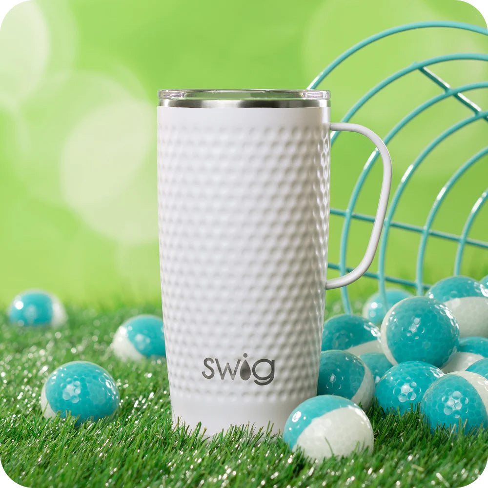 Swig Life 22oz Golf Partee Travel Mug on a green grassy background surrounded by golf balls