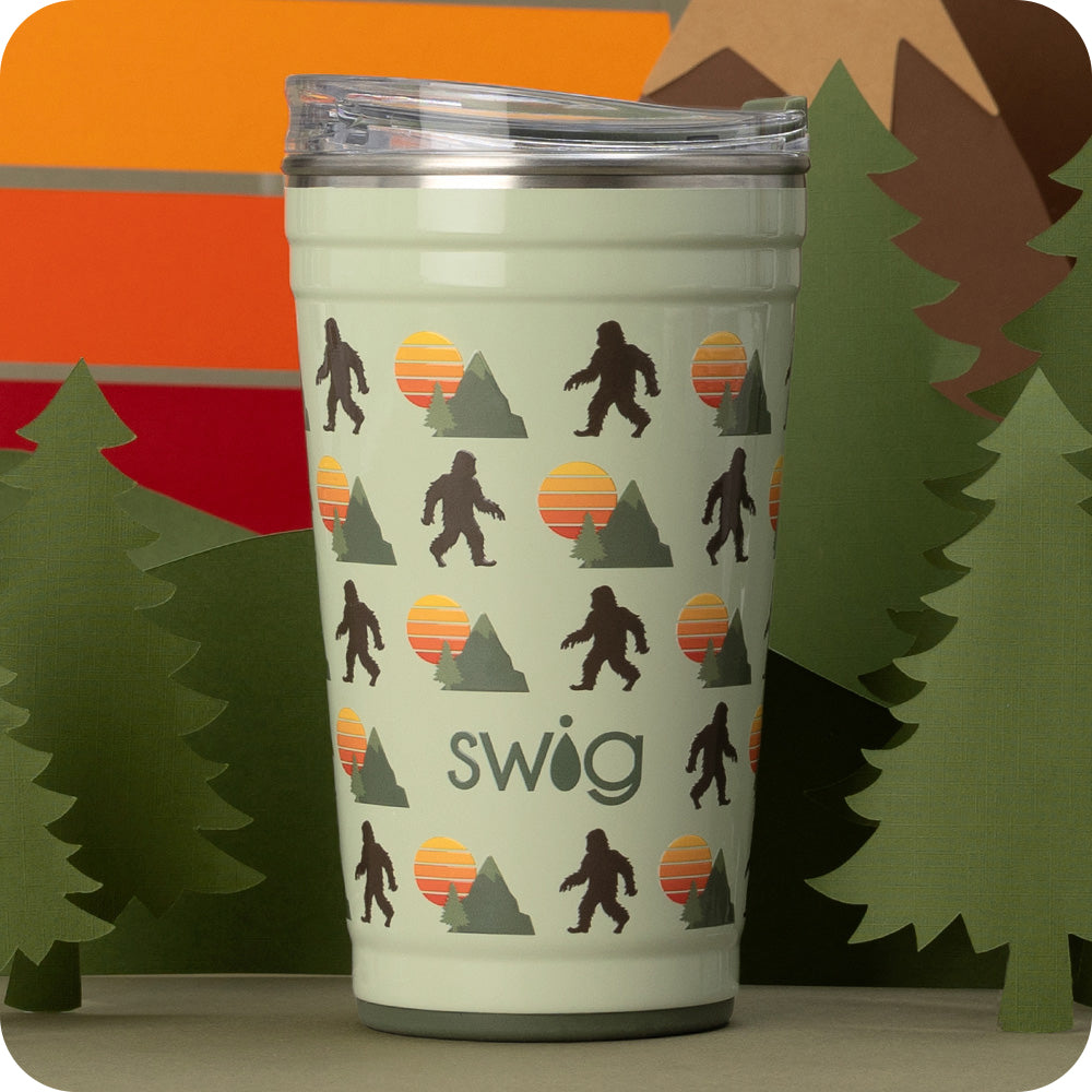 Swig Life 24oz Wild Thing Insulated Party Cup with green trees in the background