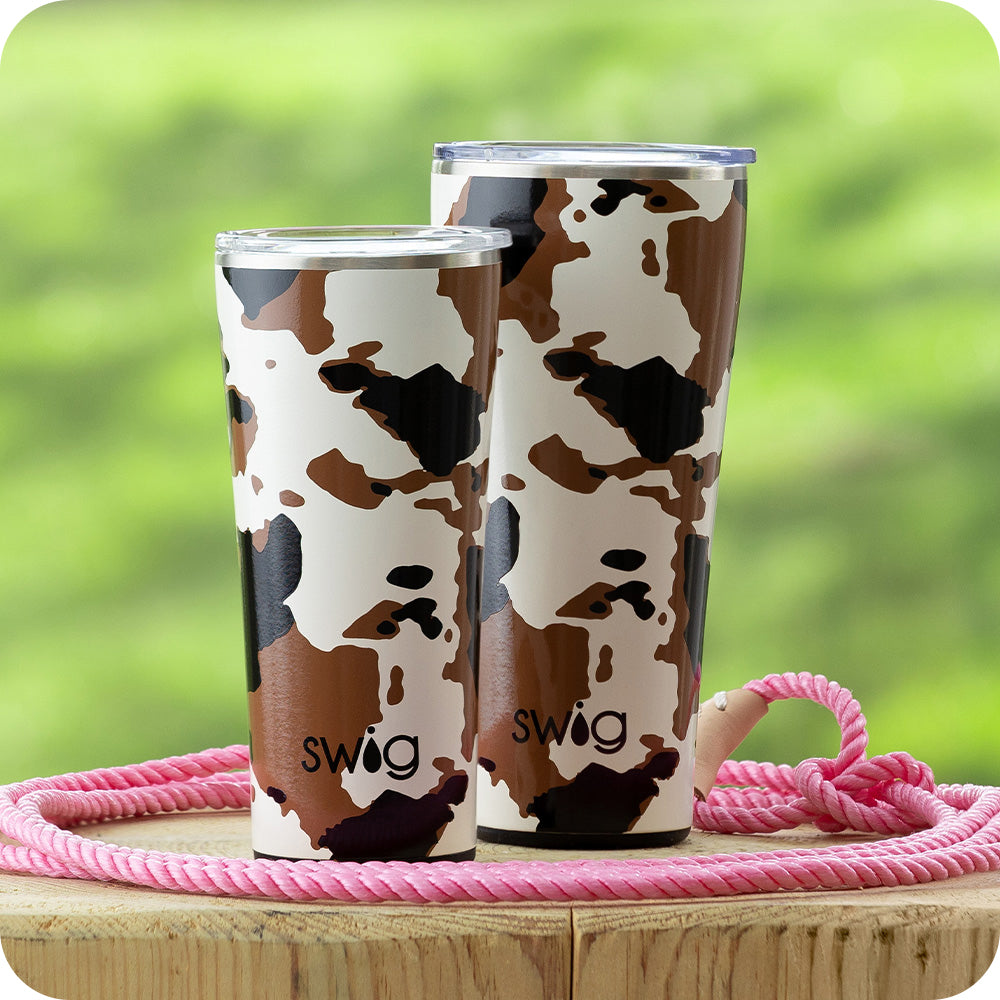 Swig Life 32oz and 22oz Hayride Insulated Tumblers with lids on a piece of wood