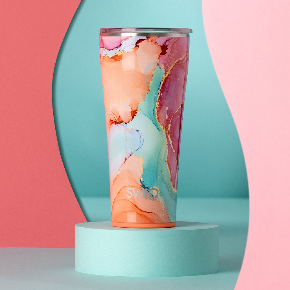 Swig Life 32oz Dreamsicle Tumbler on a teal and pink abstract background