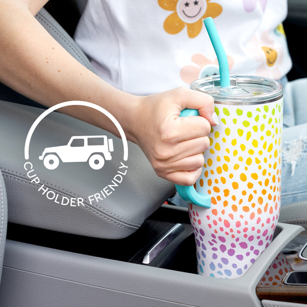 Woman placing a Swig Life 40oz Wild Child Mega Mug into her car cup holder