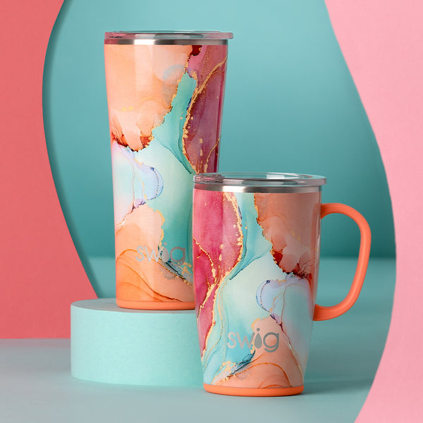 Swig Life Insulated Dreamsicle 22oz Tumbler and 18oz Travel Mug on a blue and pink background