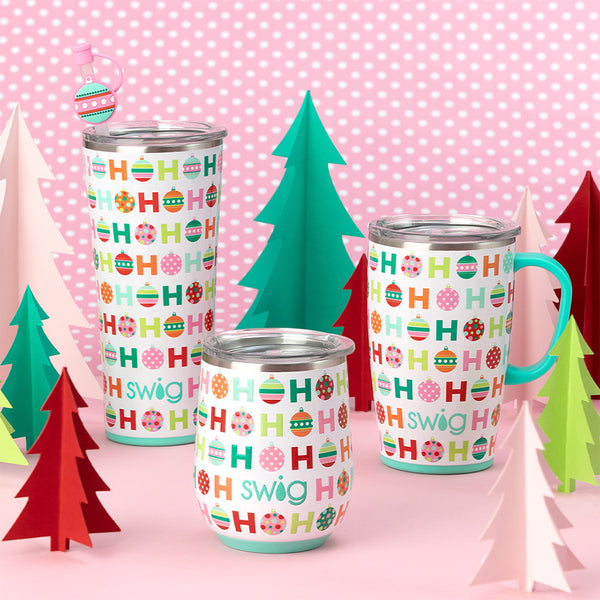 Swig Life 18oz Hohoho Travel Mug on pink background with a 22oz Hohoho Tumbler and an 12oz Hohoho Stemless Wine Cup