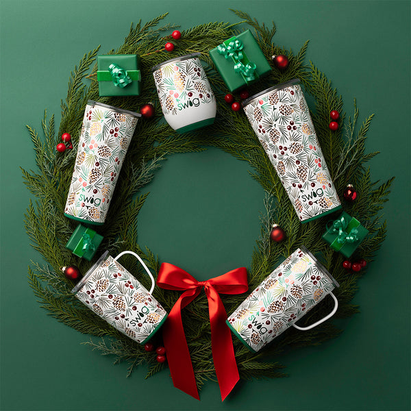 Swig Life 22oz All Spruced Up Travel Mug placed on a Holiday wreath with the Swig Life All Spruced Up Holiday collection