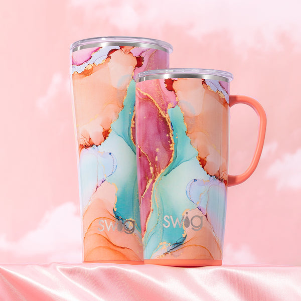 Swig Life Insulated 22oz Travel Mug and 32oz Tumbler in Dreamsicle on pink cloudy background