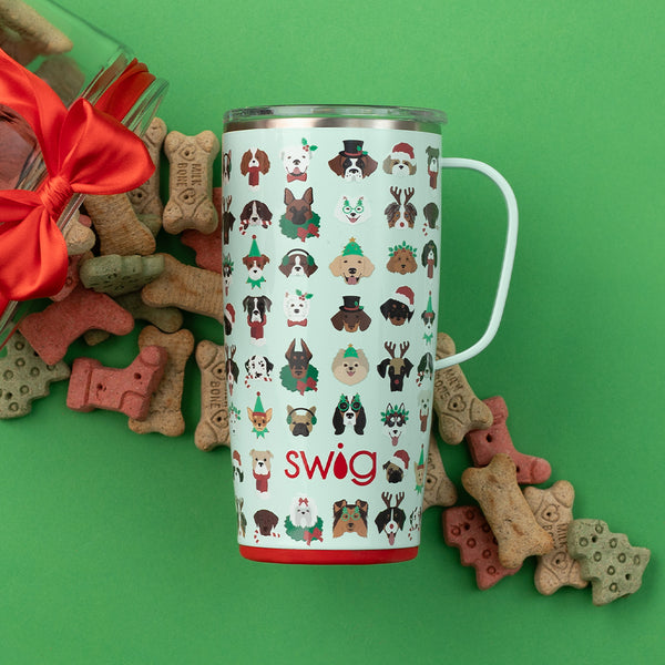 Swig Life 22oz Happy Howlidays Travel Mug on a green background with dog treats displayed underneath