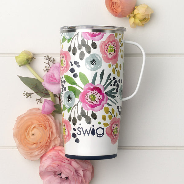 Swig Life Insulated 22oz Primrose Travel Mug surrounded by flowers on a white background