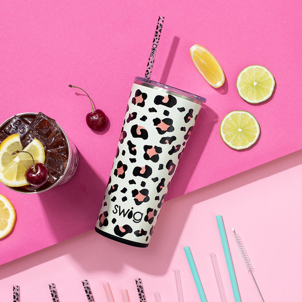 Swig Life 22oz Luxy Leopard Insualted Tumbler on a pink background with reusable straws