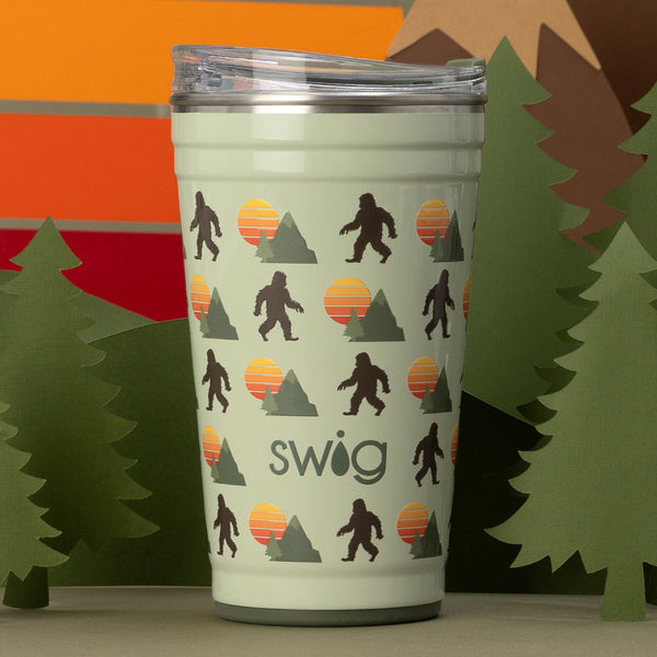 Swig Life 24oz Wild Thing Insulated Party Cup with green trees in the background