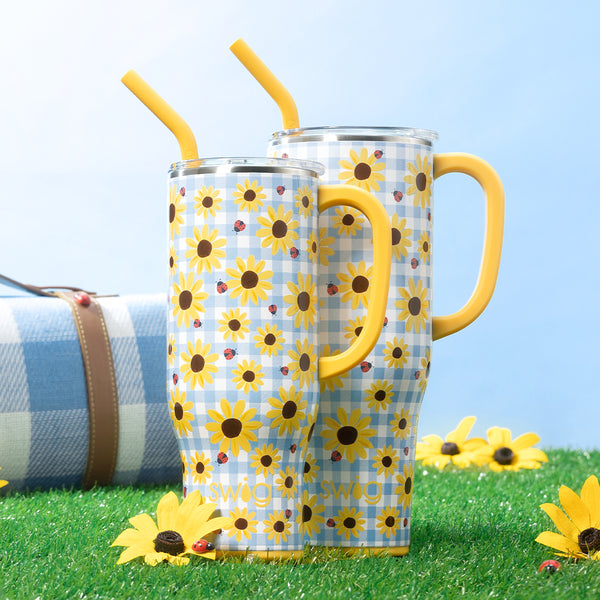 Swig Life 30oz and 40oz Picnic Basket Insulated Mega Mugs on a green grassy background with flowers, picnic blanket, and lady bugs