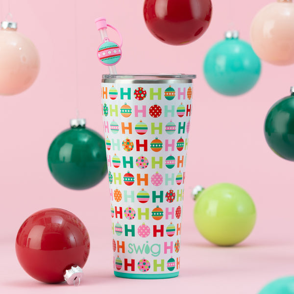Swig Life 32oz Hohoho Tumbler on a light pink background with colorful ornaments falling around it