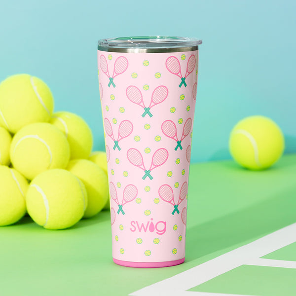 Swig Life 32oz Love All Insulated Tumbler on a tennis court with tennis balls