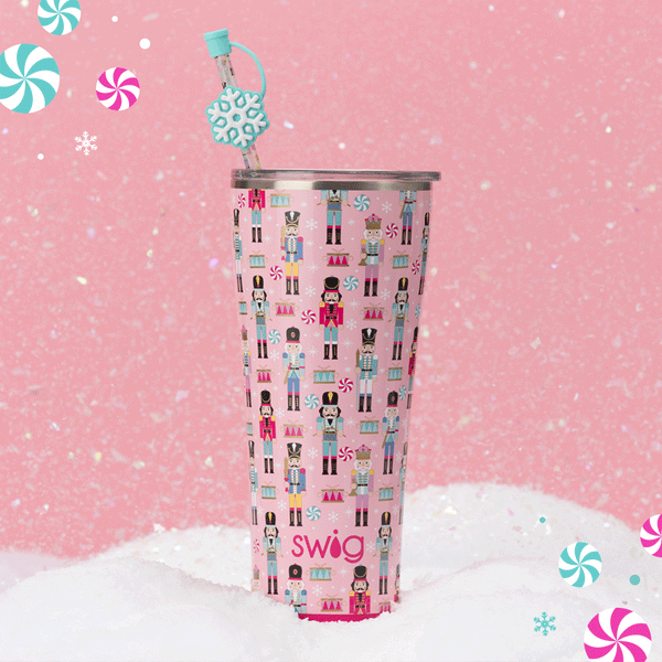Swig Life 32oz Nutcracker Tumbler over a pink background with a snowfall animation in the background and candy in the foreground