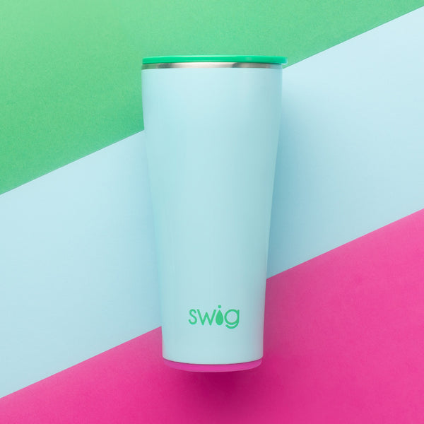 Swig Life 32oz Prep Rally Insulated Tumbler on a green, blue, and pink striped background