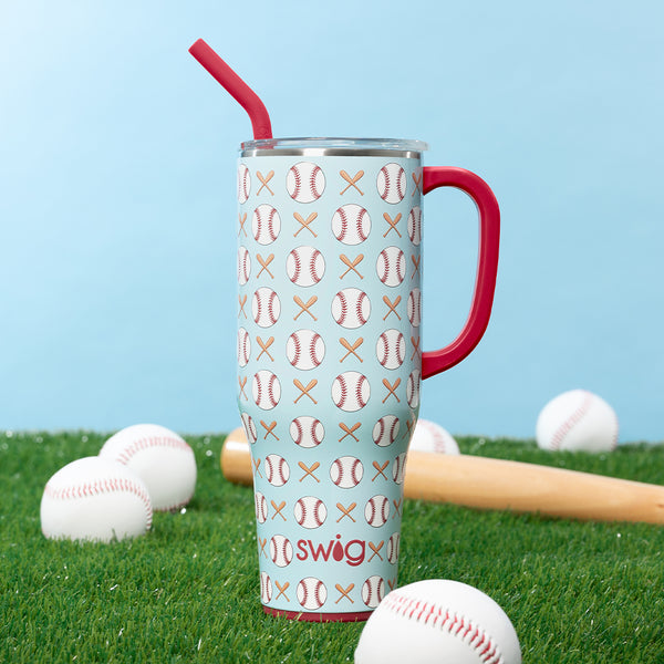 Swig Life 40oz Home Run Insulated Mega Mug with a baseball bat and baseballs on a green grassy field