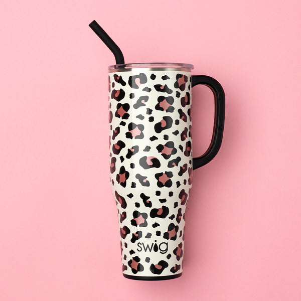 Swig Life 40oz Luxy Leopard Insulated Mega Mug with a lid and handle over a pink background
