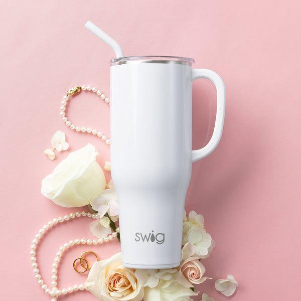 Swig Life 40oz Shimmer White Insulated Mega Mug with flowers and pearls over a pink background