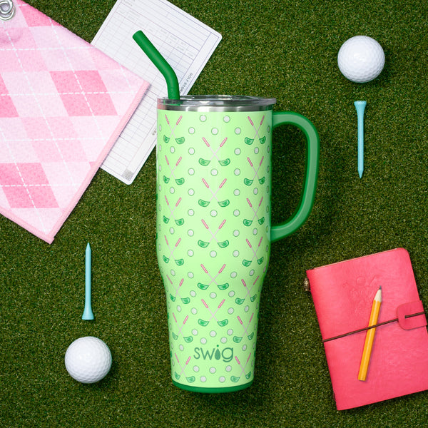 Swig Life 40oz Tee Time Insulated Mega Mug on green grass surrounded by golf balls and tees