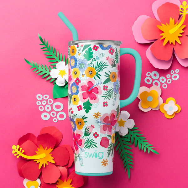 Swig Life 40oz Island Bloom Insulated Mega Mug on a hot pink background surrounded by tropical flowers
