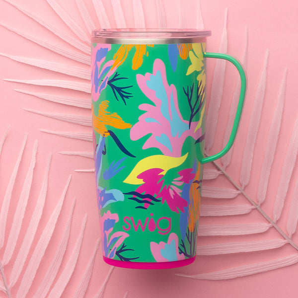 Swig Life Paradise 22oz Travel Mug on a pink leafy background