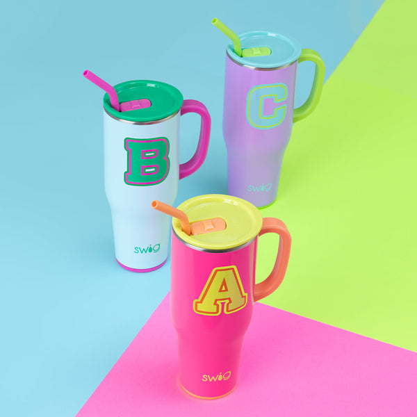 Swig Life Colorblock Initials 40oz Mega Mugs on a neon blue, green, and pink background