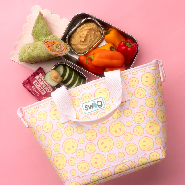 Swig Life Oh Happy Day Lunchi Lunch Bag with food coming out of it on a pink background