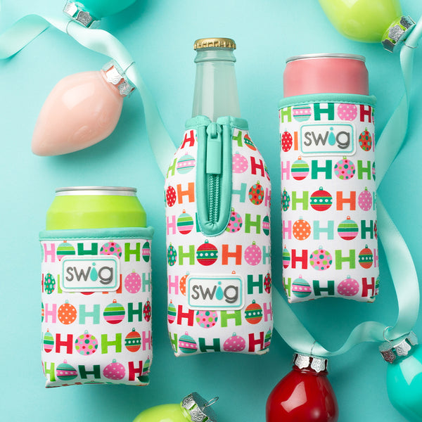 Swig Life Hohoho Can Coolie with Hohoho Bottle Coolie and Slim Can Coolie surrounded by holiday ornaments