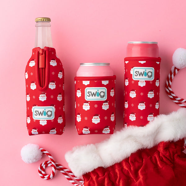 Swig Life Santa Baby Can Coolie next to Santa Baby Bottle Coolie and Slim Can Coolie coming out of a Christmas Stocking