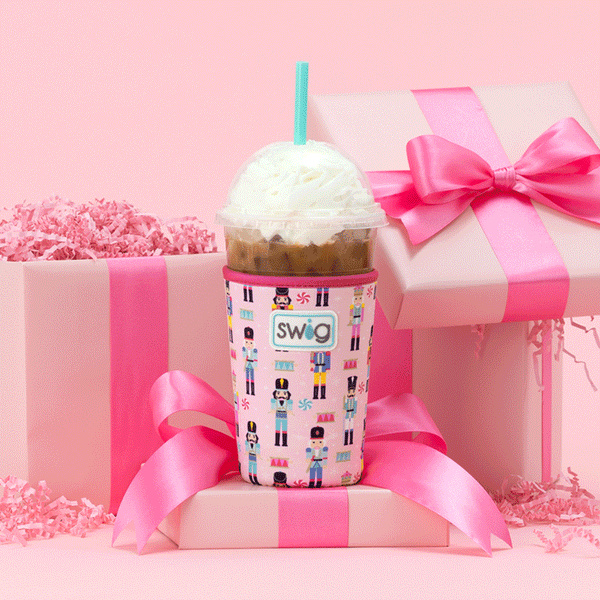 Swig Life Nutcracker Iced Cup Coolie animated to show different drinks it can hold, placed on pink gifts