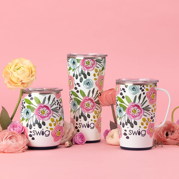 Swig Life Insulated Primrose Drinkware collection on a pink background with flowers