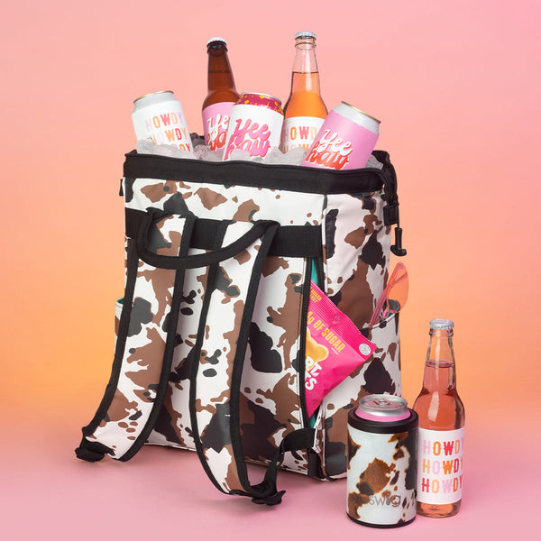 Swig Life Hayride Cow Print Packi Backpack Cooler with bottles, snacks, and ice packed into Packi Backpack Cooler