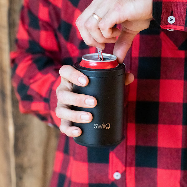 Man in red plaid holding a Swig Life 12oz Black Can + Bottle Cooler with a can inside