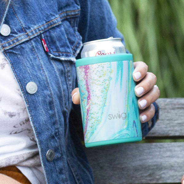 Woman in a blue denim jacket holding a Swig Life 12oz Wanderlust Can + Bottle Cooler