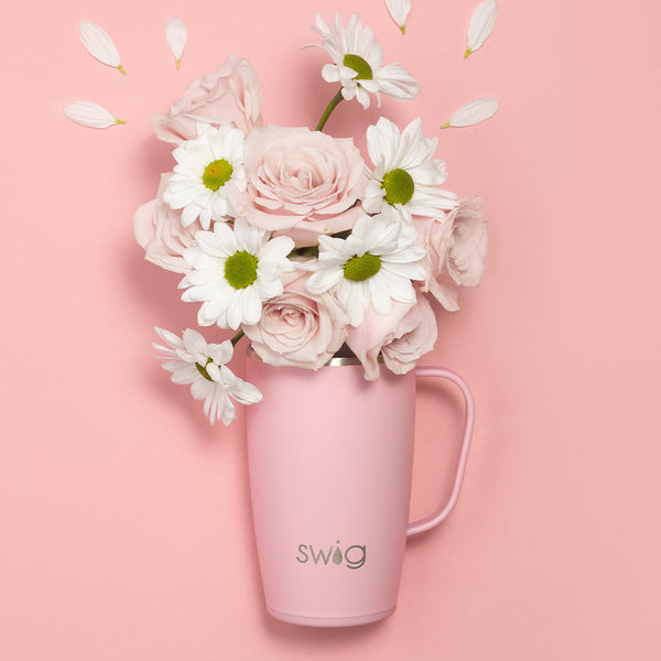 Swig Life 18oz Blush Insulated Travel Mug with flowers on a pink background