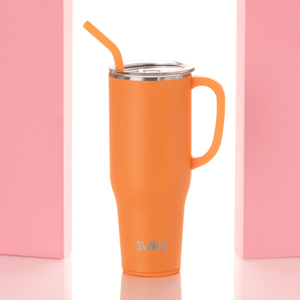 Swig Life 40oz Orange Insulated Mega Mug with lid and handle between two pink pillars